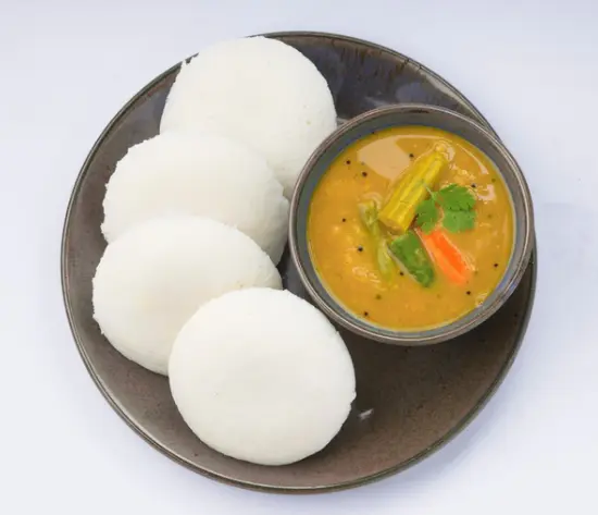 Soft steamed idly served with chutney and sambar at Balaji Dosa Live Edmonton